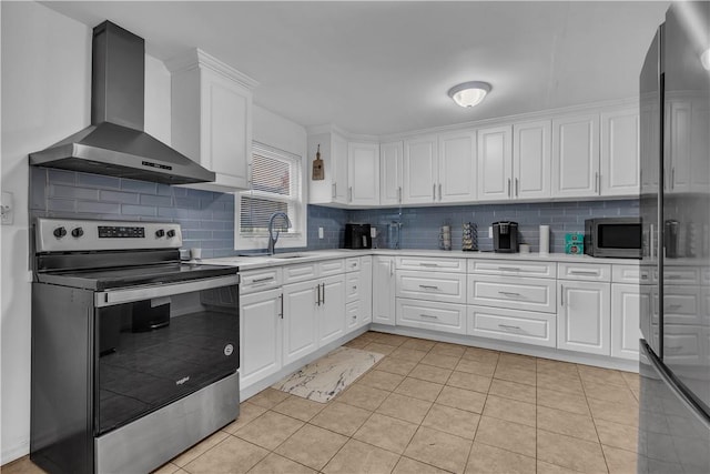 kitchen with appliances with stainless steel finishes, backsplash, wall chimney exhaust hood, sink, and white cabinets