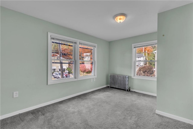 carpeted empty room with radiator heating unit