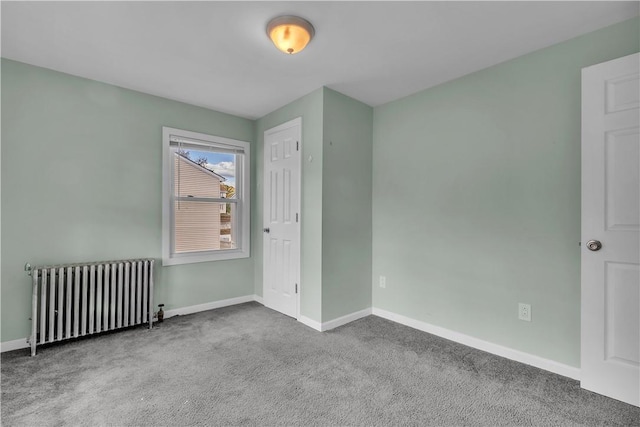 carpeted empty room with radiator heating unit