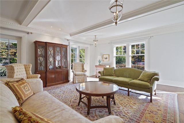 living room with beamed ceiling, light hardwood / wood-style flooring, and ornamental molding