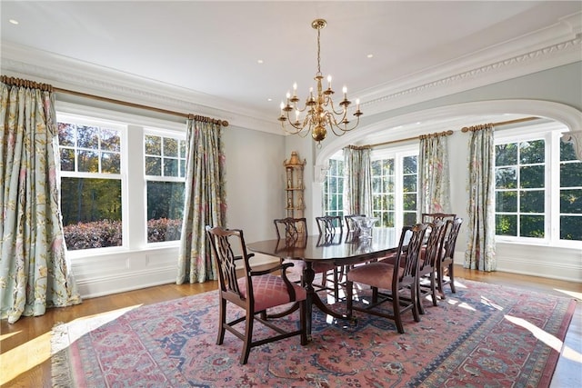 dining area featuring light hardwood / wood-style floors, ornamental molding, and a wealth of natural light