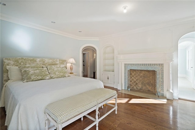 bedroom with crown molding and dark hardwood / wood-style floors