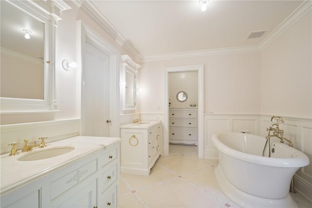 bathroom with a bathing tub, tile patterned flooring, vanity, and ornamental molding