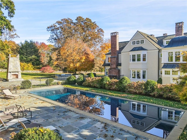 view of swimming pool with a patio area and a fireplace