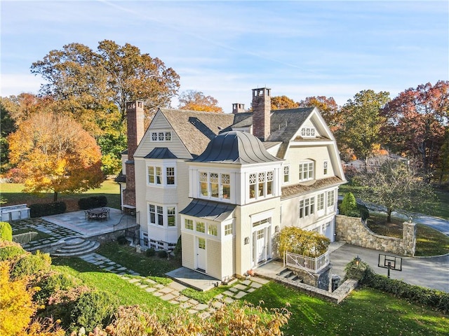 rear view of property with a patio area and a yard