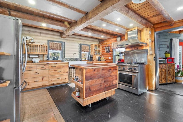 kitchen featuring beam ceiling, rustic walls, wall chimney exhaust hood, stainless steel appliances, and wood ceiling