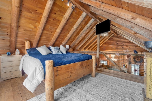 bedroom featuring wooden ceiling, light hardwood / wood-style flooring, lofted ceiling with beams, and wood walls