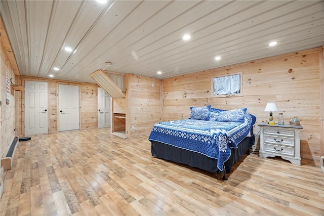 bedroom featuring light wood-type flooring, wooden ceiling, and wood walls