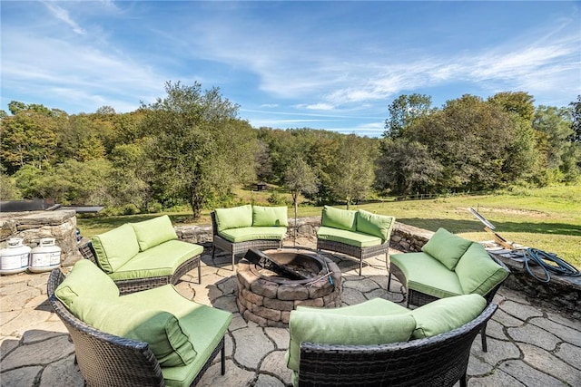 view of patio featuring an outdoor living space with a fire pit