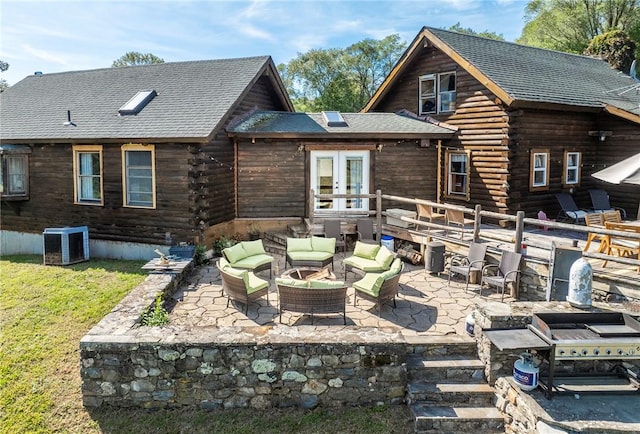 back of house featuring outdoor lounge area, a patio area, french doors, and central AC