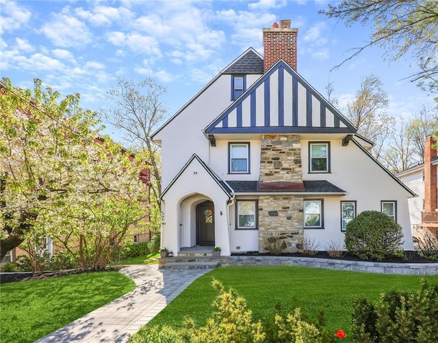 english style home with a front lawn