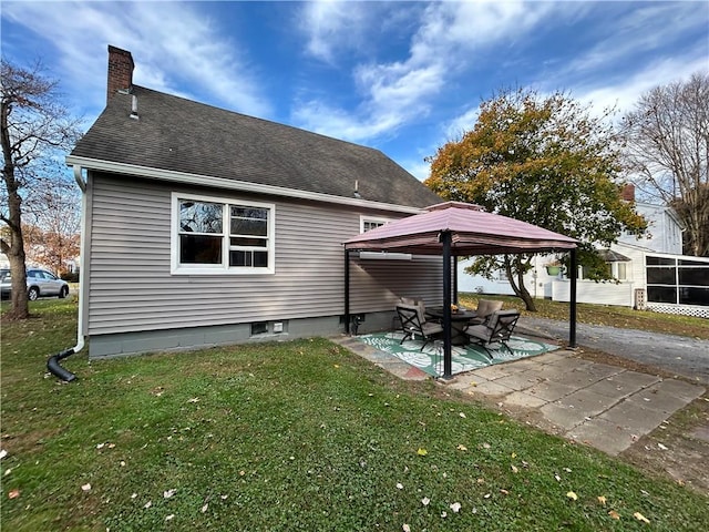 rear view of house featuring a gazebo, a yard, and a patio