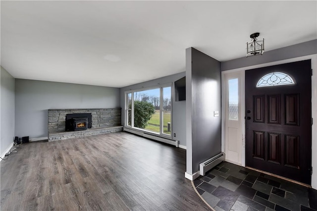 foyer entrance featuring dark wood-type flooring and a baseboard heating unit