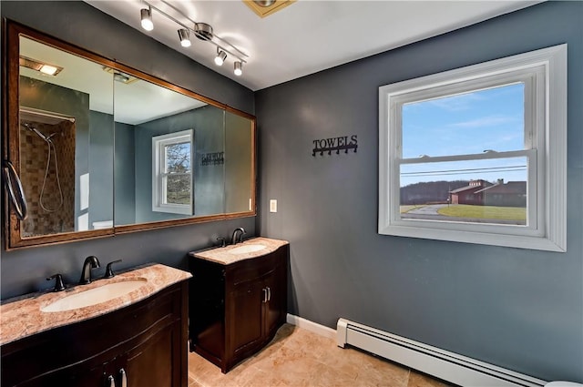 bathroom with tile patterned flooring, vanity, and a baseboard heating unit