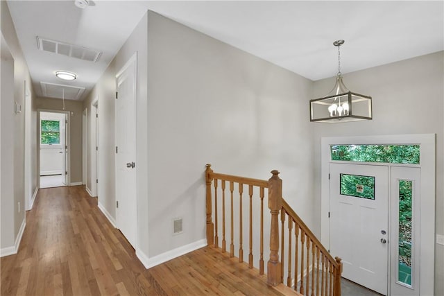 2 Requa St, Briarcliff Manor, NY 10510 - entryway featuring wood finished floors, baseboards, and a chandelier