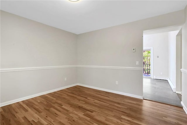 spare room with dark hardwood / wood-style flooring