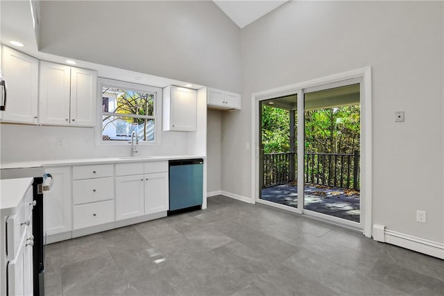 2 Requa St, Briarcliff Manor, NY 10510 - kitchen with dishwashing machine, a sink, a baseboard heating unit, white cabinets, and a towering ceiling