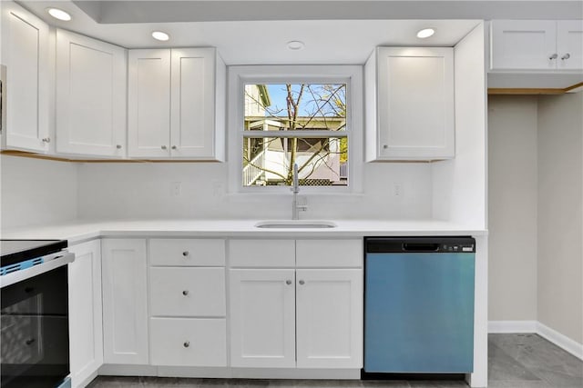 kitchen featuring dishwasher, stove, white cabinets, and sink