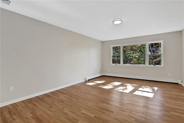 2 Requa St, Briarcliff Manor, NY 10510 - spare room featuring baseboard heating, wood finished floors, and baseboards