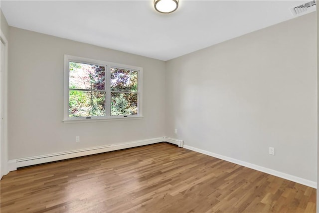 2 Requa St, Briarcliff Manor, NY 10510 - spare room with a baseboard heating unit, wood finished floors, and baseboards