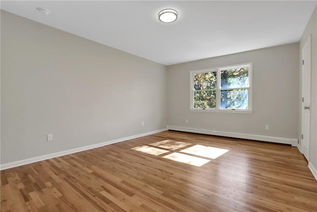 2 Requa St, Briarcliff Manor, NY 10510 - unfurnished room with a baseboard heating unit, wood finished floors, baseboards, and a smoke detector