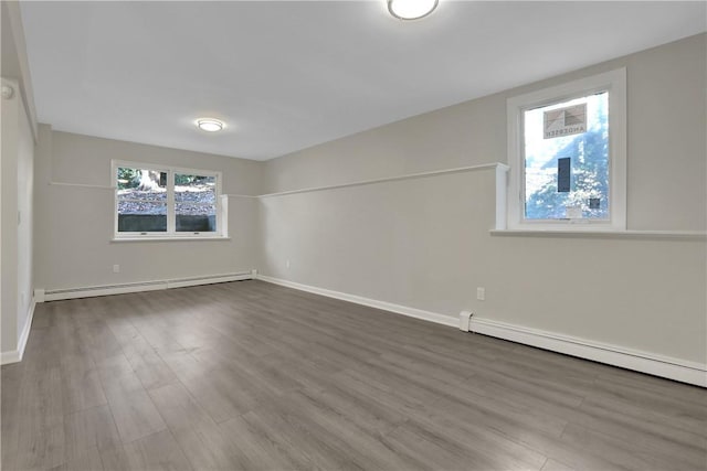 2 Requa St, Briarcliff Manor, NY 10510 - unfurnished room with a baseboard heating unit, dark wood-style flooring, baseboards, and baseboard heating