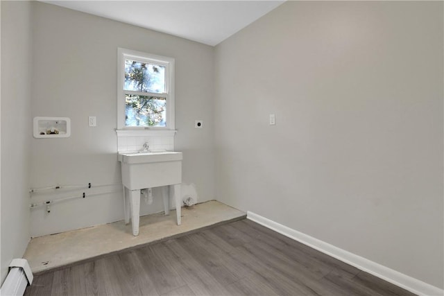 2 Requa St, Briarcliff Manor, NY 10510 - laundry area featuring a baseboard heating unit, wood finished floors, hookup for a washing machine, and electric dryer hookup