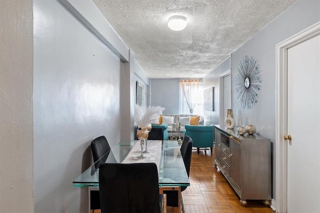 dining room with a textured ceiling and light parquet floors