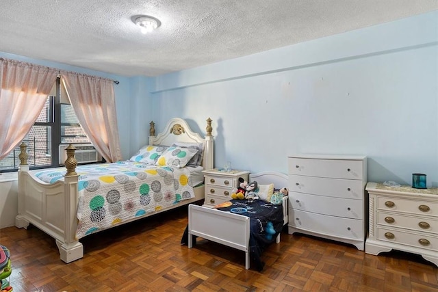 bedroom featuring a textured ceiling, dark parquet floors, and cooling unit