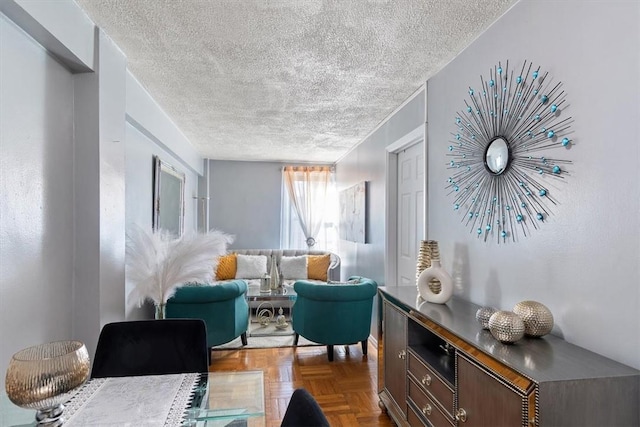 sitting room featuring parquet floors and a textured ceiling