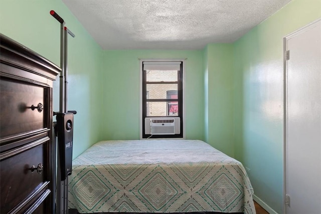 bedroom featuring a textured ceiling and cooling unit