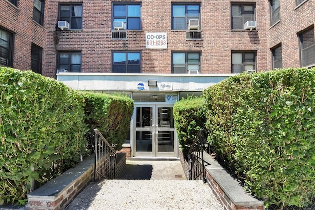 property entrance featuring french doors and cooling unit