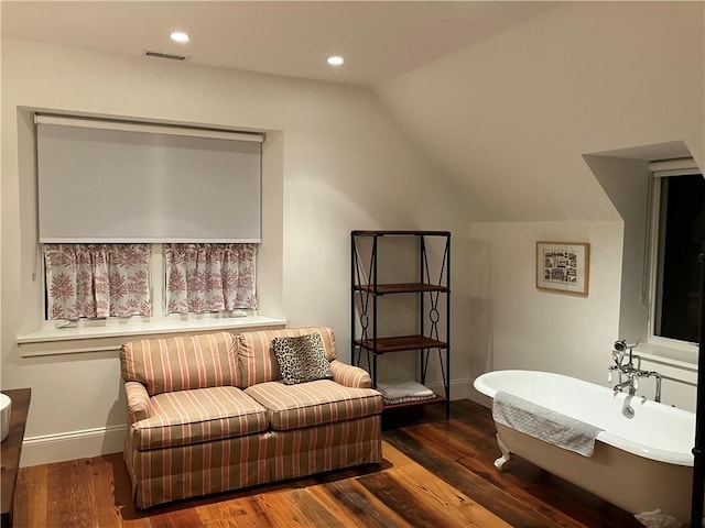 sitting room featuring lofted ceiling and dark wood-type flooring