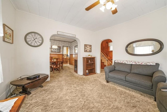 living room with ceiling fan and light colored carpet