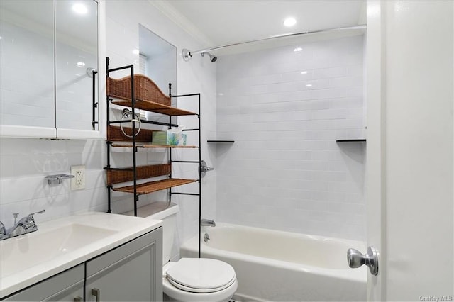 full bathroom featuring vanity, tiled shower / bath combo, toilet, ornamental molding, and tasteful backsplash