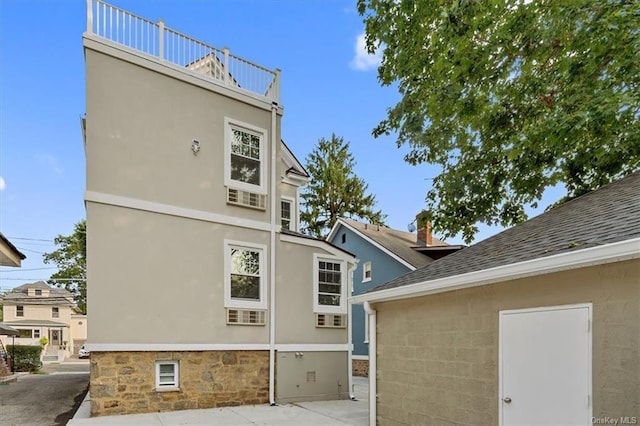 back of house featuring a balcony