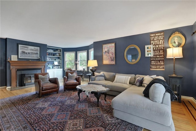 living room with hardwood / wood-style flooring and built in features