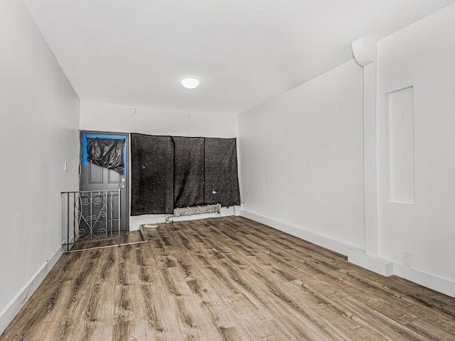 spare room with wood-type flooring