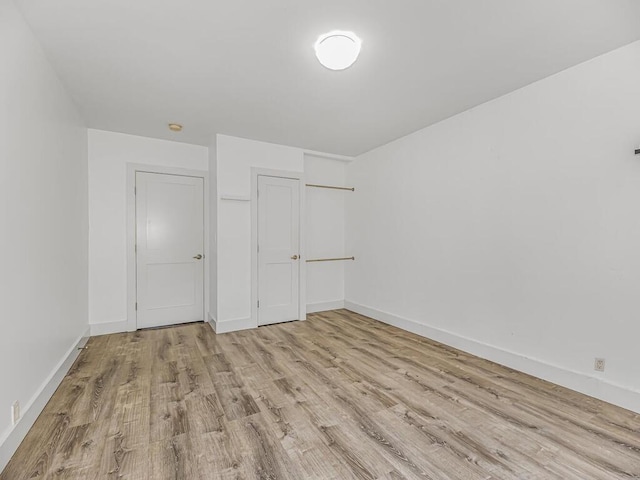 unfurnished bedroom with light wood-type flooring