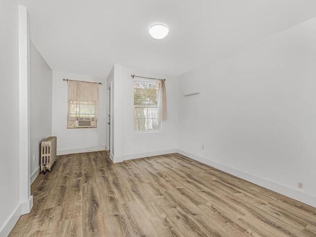 spare room with light hardwood / wood-style floors and radiator