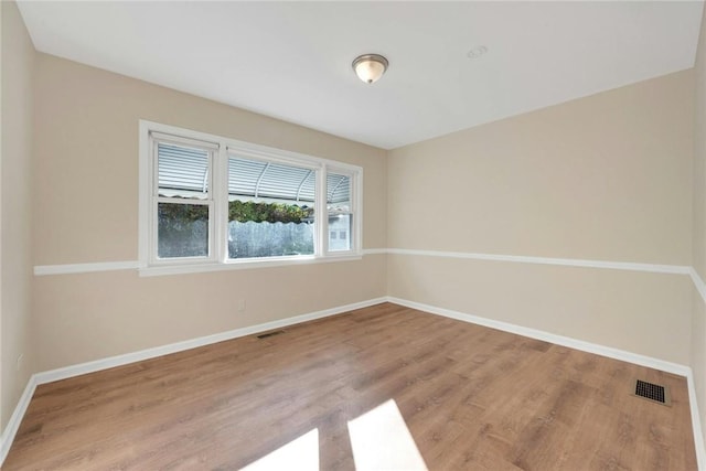 spare room with wood-type flooring