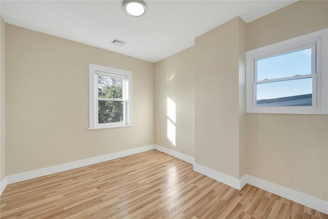 empty room with light hardwood / wood-style floors