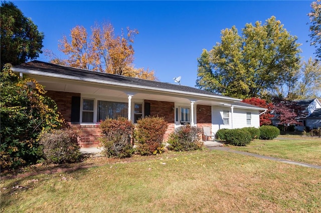 ranch-style house with a front lawn and covered porch