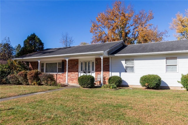 ranch-style home with covered porch and a front yard