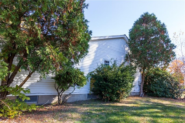 view of side of home featuring a lawn