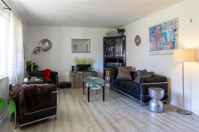 living room with plenty of natural light and light hardwood / wood-style floors