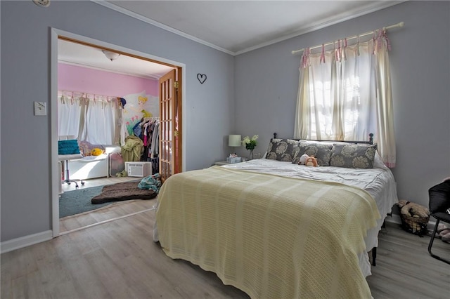 bedroom featuring hardwood / wood-style flooring and crown molding