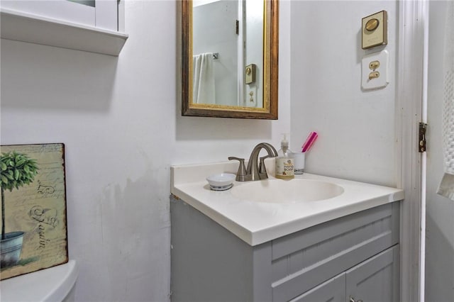 bathroom featuring vanity and toilet