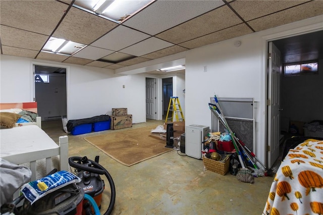 basement with a paneled ceiling