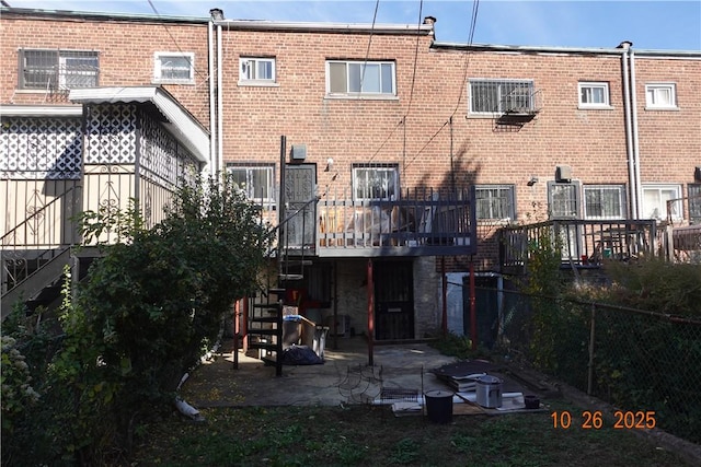 back of house with a wooden deck, a patio, and central AC unit